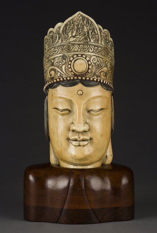 small carved ivory buddha