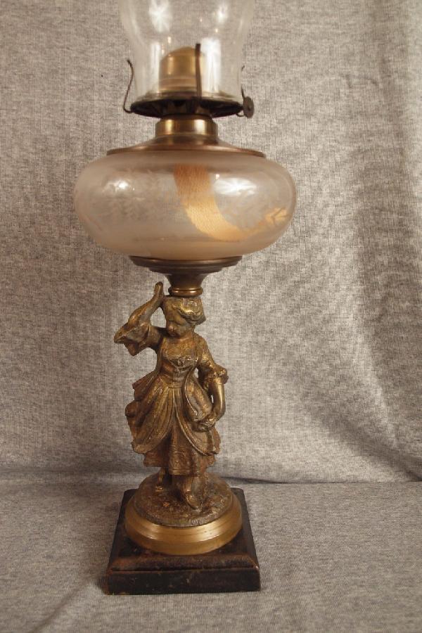 35 Peg oil lamp with figure of lady on base Lot 35