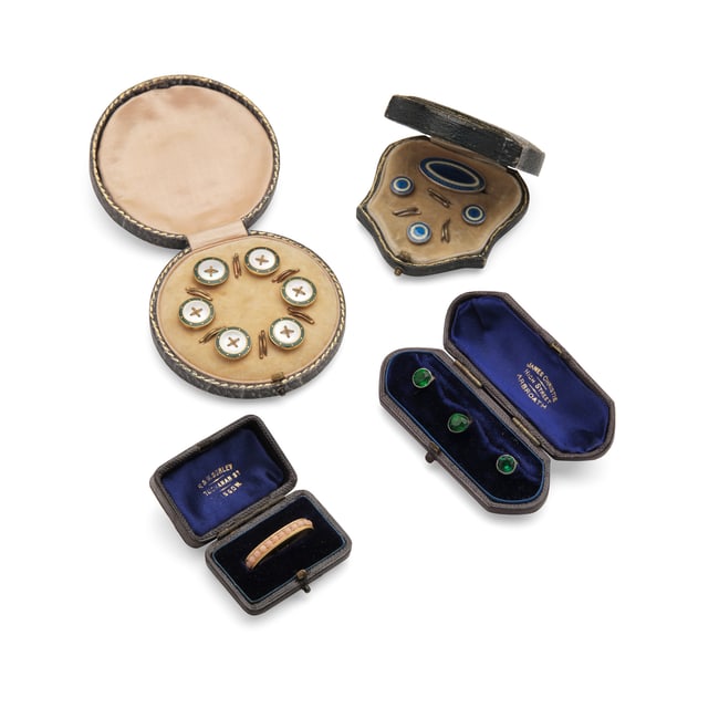 A collection of cased studs and buttons